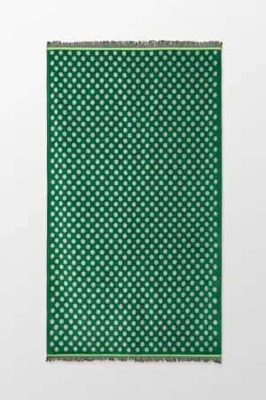 toalla de playa verde con lunares blancos